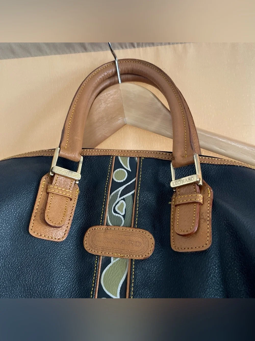 Black Leather Duffel Bag with Brown Trim and Olive Pattern Accent